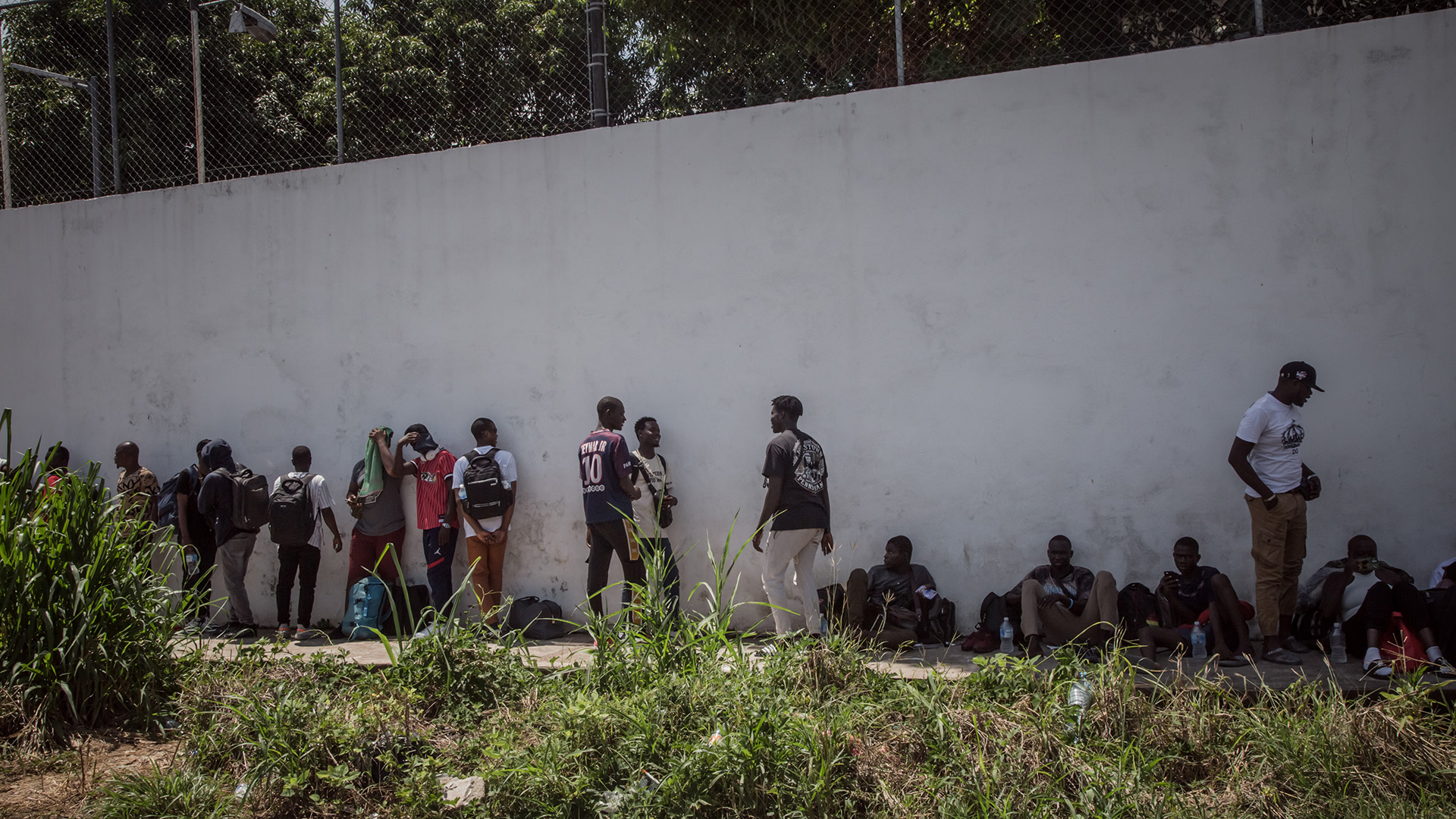 Migrant individuals wait in line along the perimeter of the COMAR (the Mexican Commission to Aid Refugees) premises, September 11, 2023. HIAS is on hand to provide counsel and assistance regarding the application process.