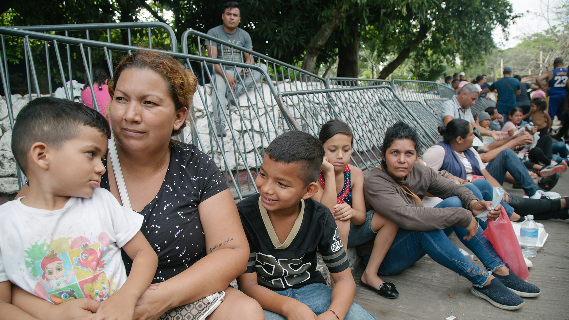 Claudia, a refugee from Honduras, is seen here with her son Ian and Luis Emilio at the new COMAR (Mexican Commission to Assist Refugees) site in Tapachula, Mexico, on September 11, 2023. These individuals endure lengthy waits, often necessitating overnight stays in line, as they await appointments for humanitarian visas after fleeing Honduras.
